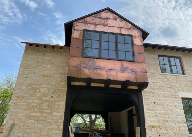 Copper metal panel facade on a stone building for Skylight Installation in West Jordan